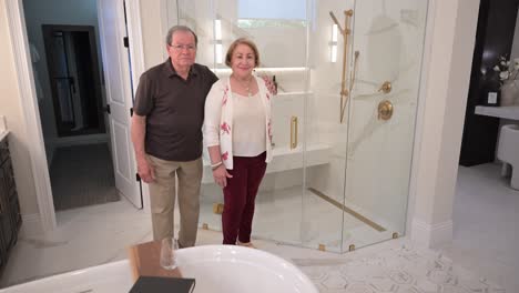 couple of happy customers with their new master bathroom and glass shower