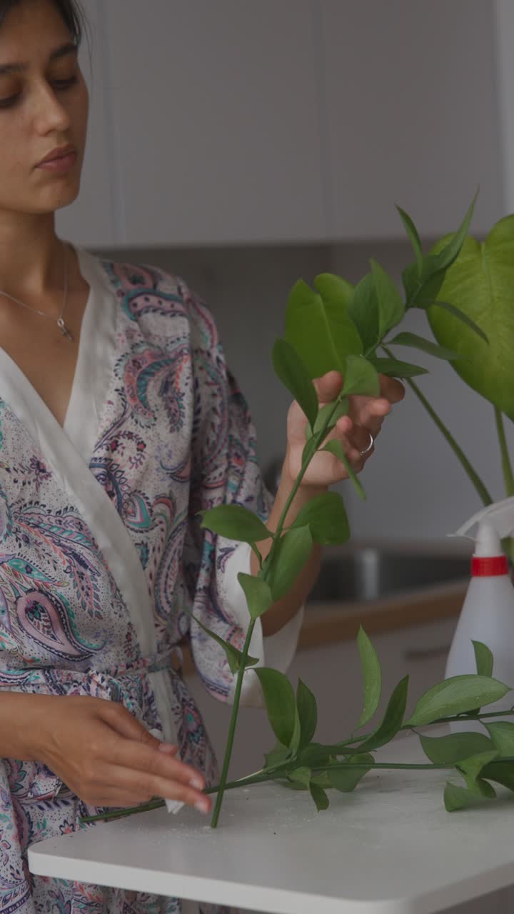Woman Arranging Flowers in Kitchen