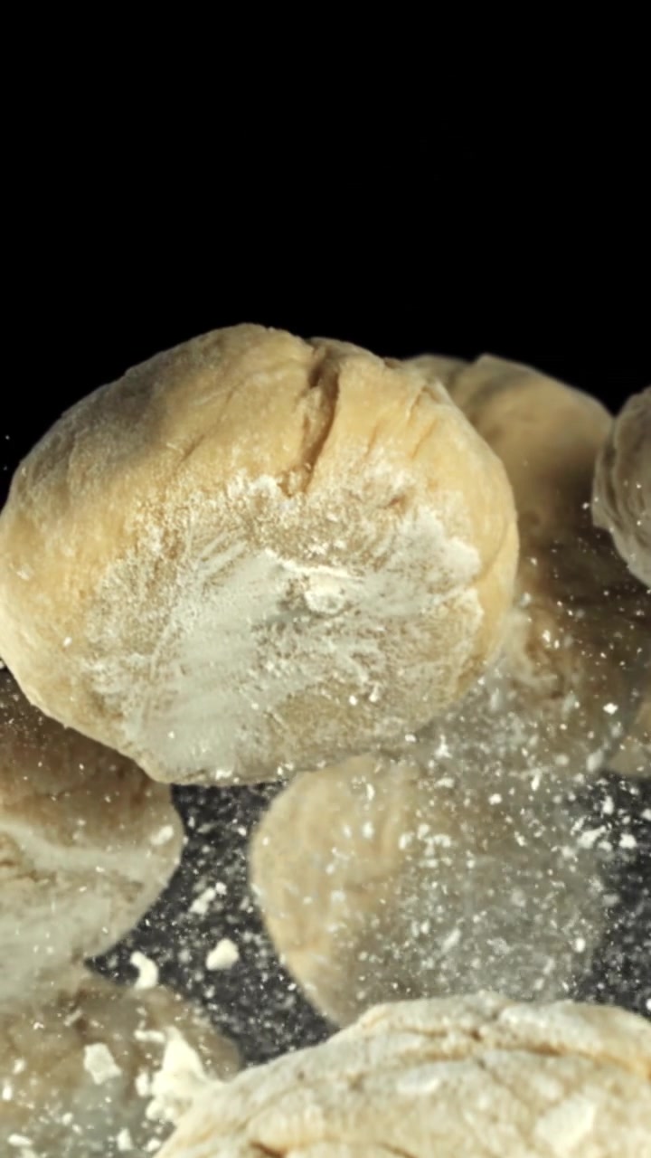 Slow Motion of Flour Sprinkling Over Raw Dough for Baking