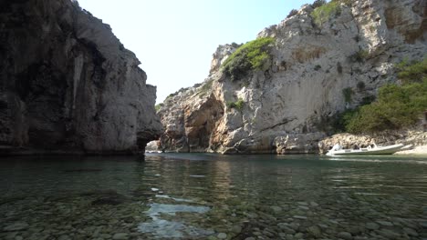 Low-angle-view-of-calm-clear-water-in-a-hidden-lagoon-on-a-Croatian-island-in-the-Adriatic