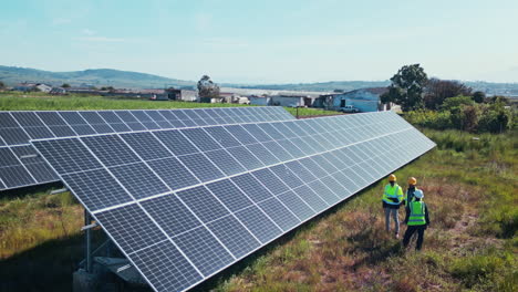Drone-of-solar-panels,-engineering-people