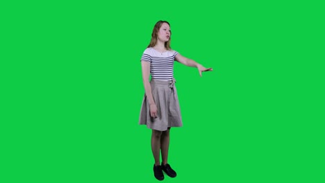 Side-view,-teenage-girl-singing,-vibing-to-music-in-front-of-a-green-screen