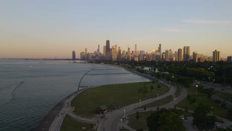 establishing shot above chicago lakeshore running walking path on summer evening