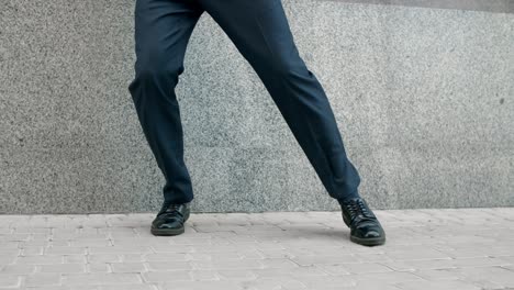 closeup man feet dancing outside. cropped image man in shoes dancing at street