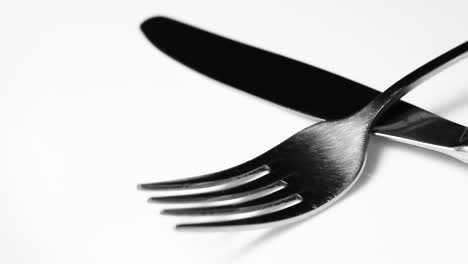 knife and fork on white surface close up video