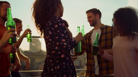 Close-up-view-of-multiracial-friends-hanging-out-on-rooftop-terrace