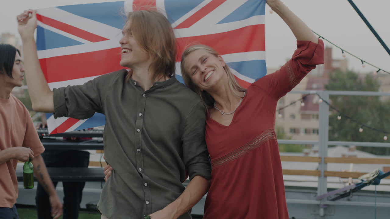 Couple celebrates with UK flag at rooftop party