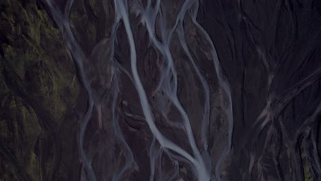 iceland's braided glacial run offs - aerial top down view scrolling up