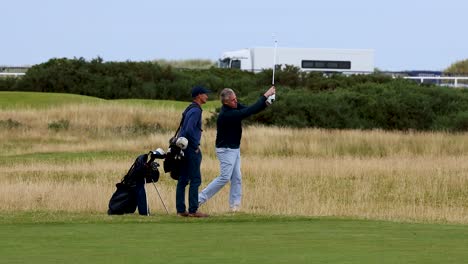 two men playing golf on a field