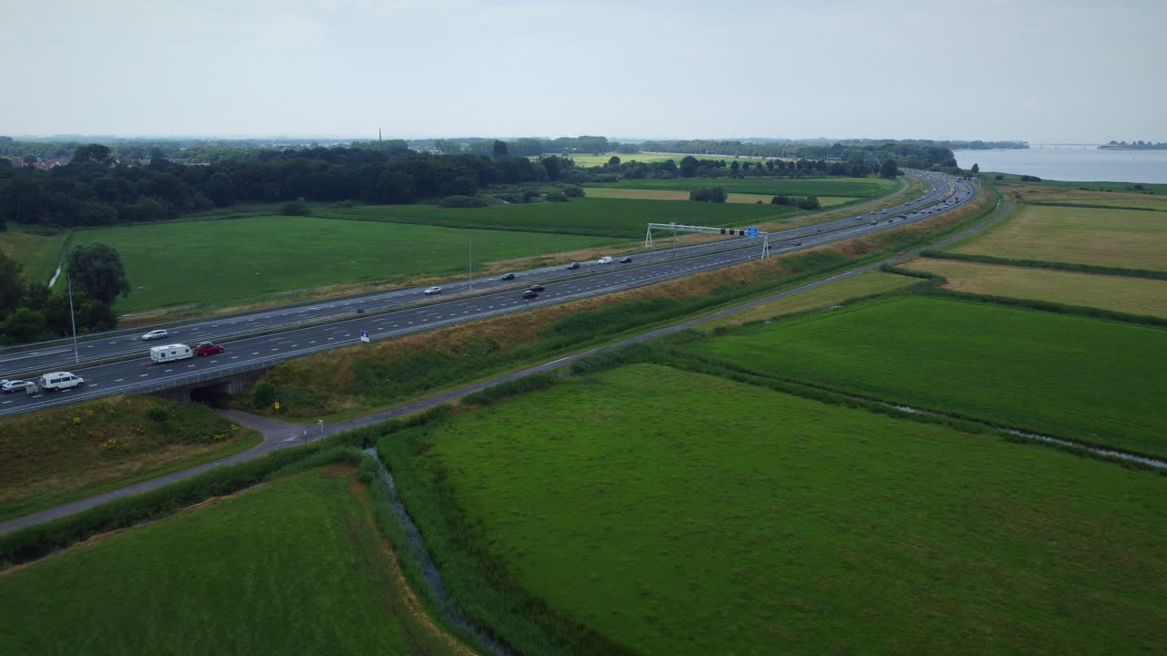 Aerial shot of motorway in the Netherlands, dolly out.