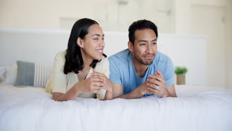 happy family playing on a bed