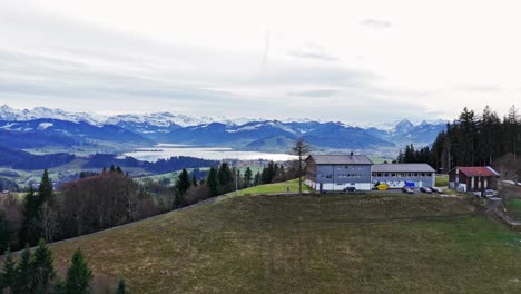 aerial view of swiss town einsiedeln and lake sihlsee, snowy mountains