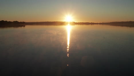 stunning view of morning sunrise with birds flying on a peaceful beach on a cold morning in new zealand