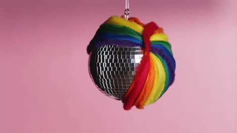 a disco ball wrapped in a rainbow pride flag