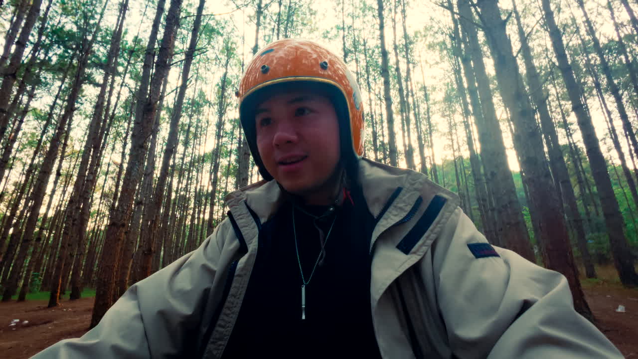 Person Riding Scooter in a Pine Forest