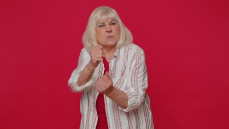 Aggressive-angry-woman-trying-to-fight-at-camera,-shaking-fist,-boxing-with-expression,-punishment