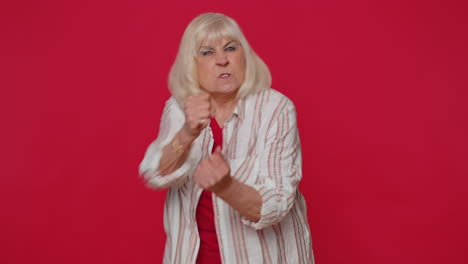aggressive angry woman trying to fight at camera, shaking fist, boxing with expression, punishment