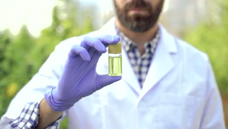 focused scientist showing cannabis pill