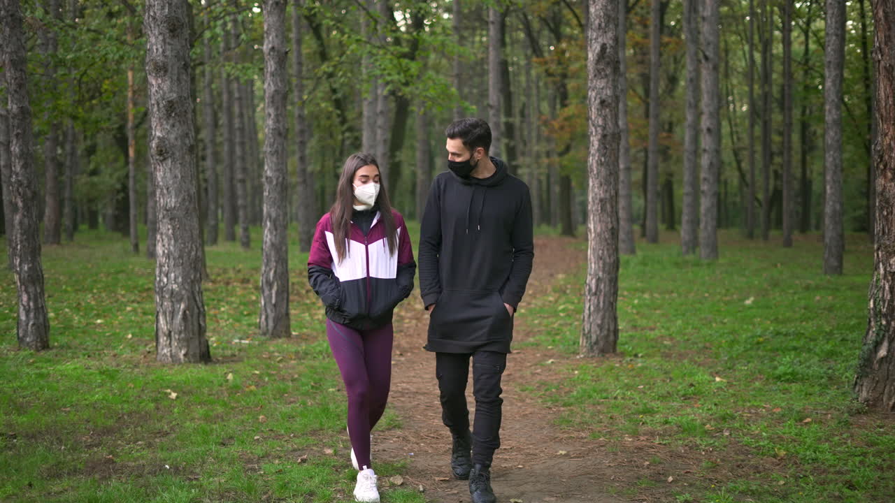 People in face mask walking in a forest