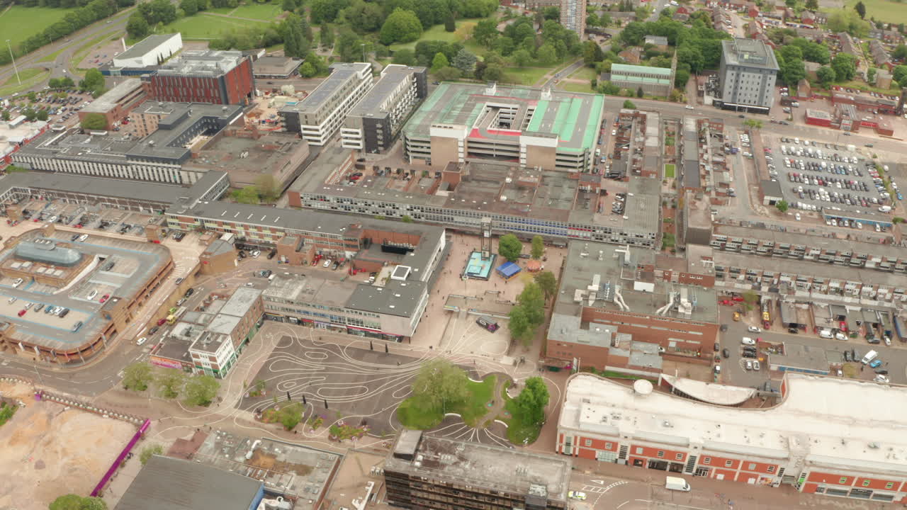 Circling aerial shot around Stevenage town square clock tower