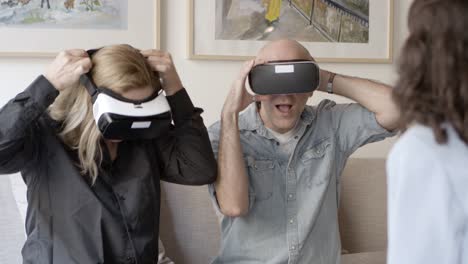 front view of excited mature people testing vr glasses