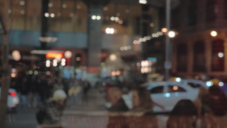 People-crossing-the-street-Evening-city-view-through-the-window