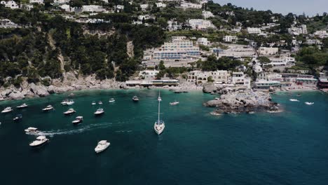 Aerial-view-flying-towards-Italy's-tourist-packed-beaches