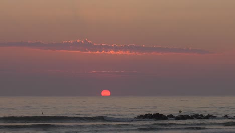 relaxing beach sunrise with sunlit clouds, mediterranean sea