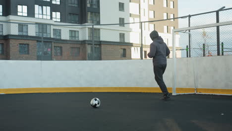 athlete jogging in an urban outdoor sports arena near a soccer goalpost, showcasing fitness and determination with high-rise residential buildings in the background