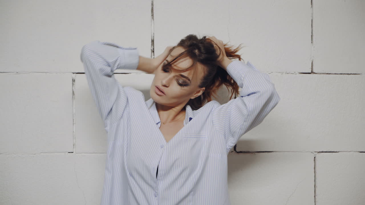 Woman Portrait against White Brick Wall