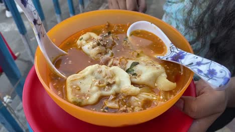 Von-Oben-Nach-Unten-Geschossen-über-Gedämpftem-Momo-Mit-Suppe,-Serviert-In-Einer-Gelben-Schüssel