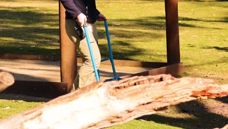 staff member maintaining zoo environment with tools