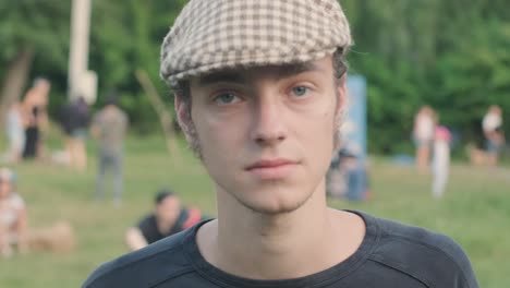 portrait of a young cute guy wearing a cap smiling to the camera