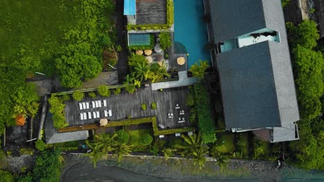 Cinematic-drone-footage-of-Berawa-beach-in-Canggu,-Bali-with-beautiful-landscape,-expensive-hotels-and-villas-through-calm-weather