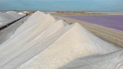 flying over the white salt piles in bonaire contrasted with the colorful pink salt ponds