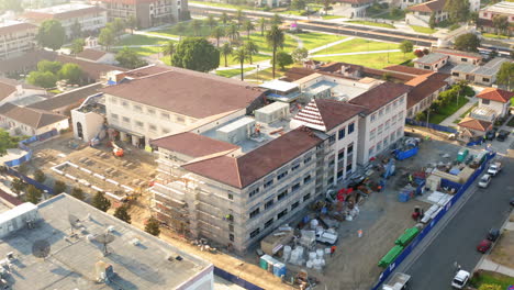 aerial view of a large building under construction on a campus