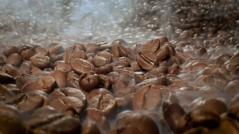 close up of seeds of coffee. fragrant coffee beans are roasted smoke comes from coffee beans.