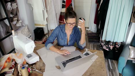 Female-with-laptop-and-coffee-in-parlour