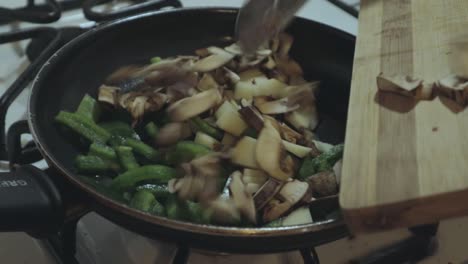 cooking vegetables in a hot pan on the stove