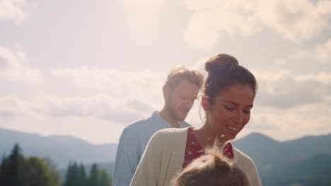 Happy-parents-two-children-resting-on-summer-mountains.-Family-vacation-on-hill.