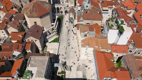 people walking through eastern (silver) gate to saint domnius cathedral in split, croatia. - aerial shot