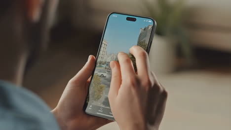 hands interacting with a smartphone displaying a map or app interface