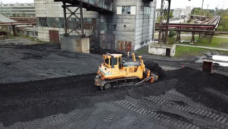 coal mining industry. yellow tractor loading the coal in construction site