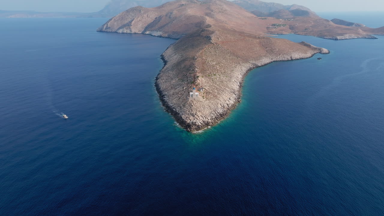 Drone circles Cape Tainaron cliffs above deep Aegean blue waters at southern Greece’s tip