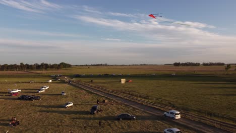 people enjoy flying kite outdoor in open air in wide green field, buenos aires, argentina