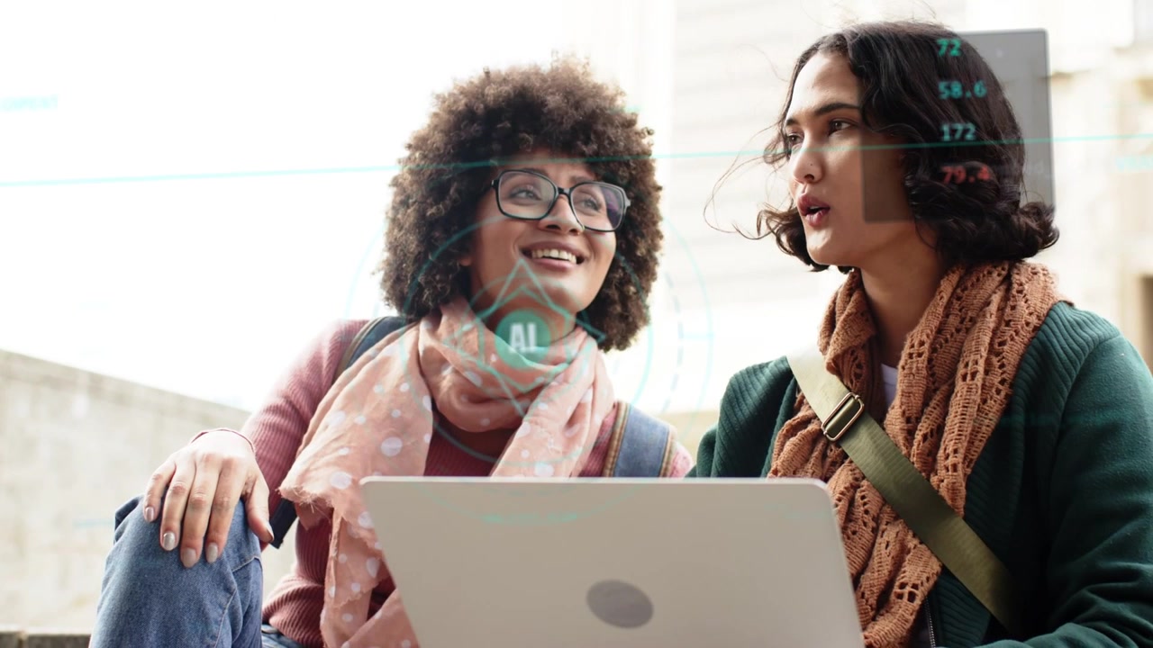 Two women sitting on steps, left woman pointing at laptop, activating AI HUDs over faces, education