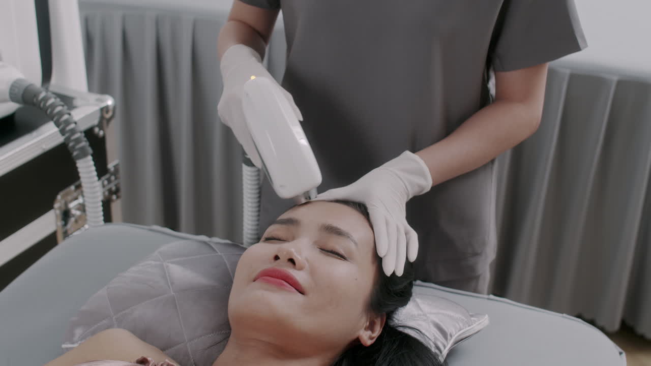 Woman Having Anti-wrinkle Laser Treatment on Forehead