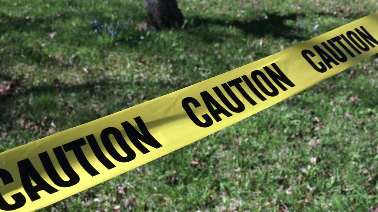 Warning for caution written on yellow ribbon