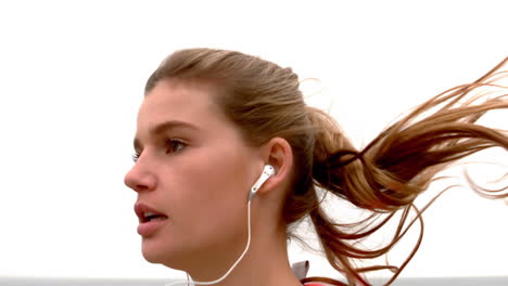 Sporty-woman-with-headphones-jogging