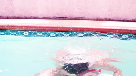 male coming up for air in a pool